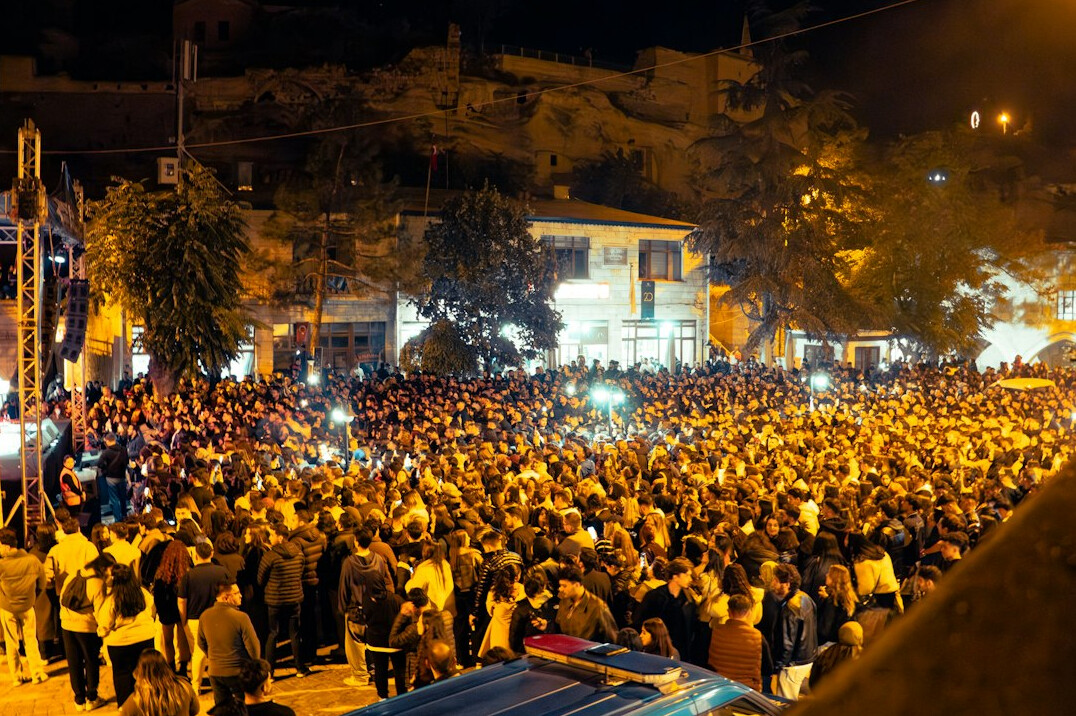Crowd at an evening event with stage lights